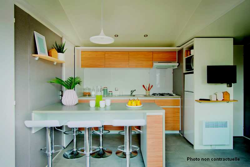 Kitchen equipped with central island in premium mobile home at the lake campsite in Curbans